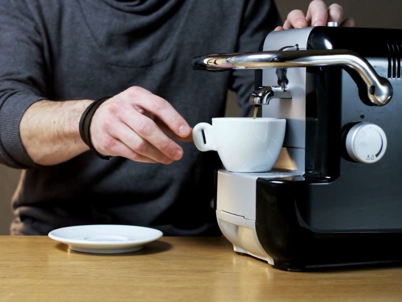 momak pravi kafu iz aparata